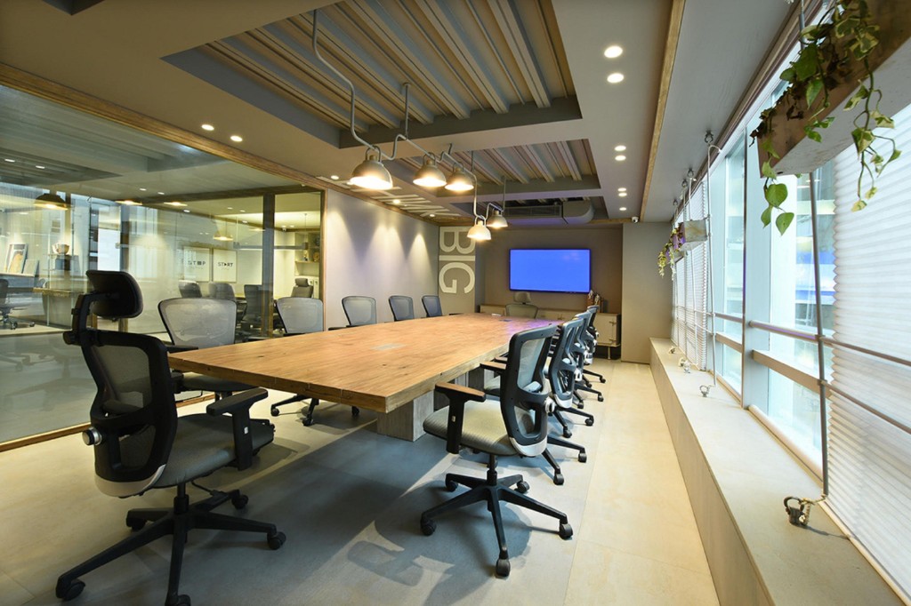 Modern conference room with a long meeting table and chairs
